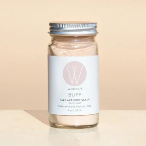 4 oz glass container containing ultra fine pink powder with Wildcraft product label for Buff Face and Body Scrub
